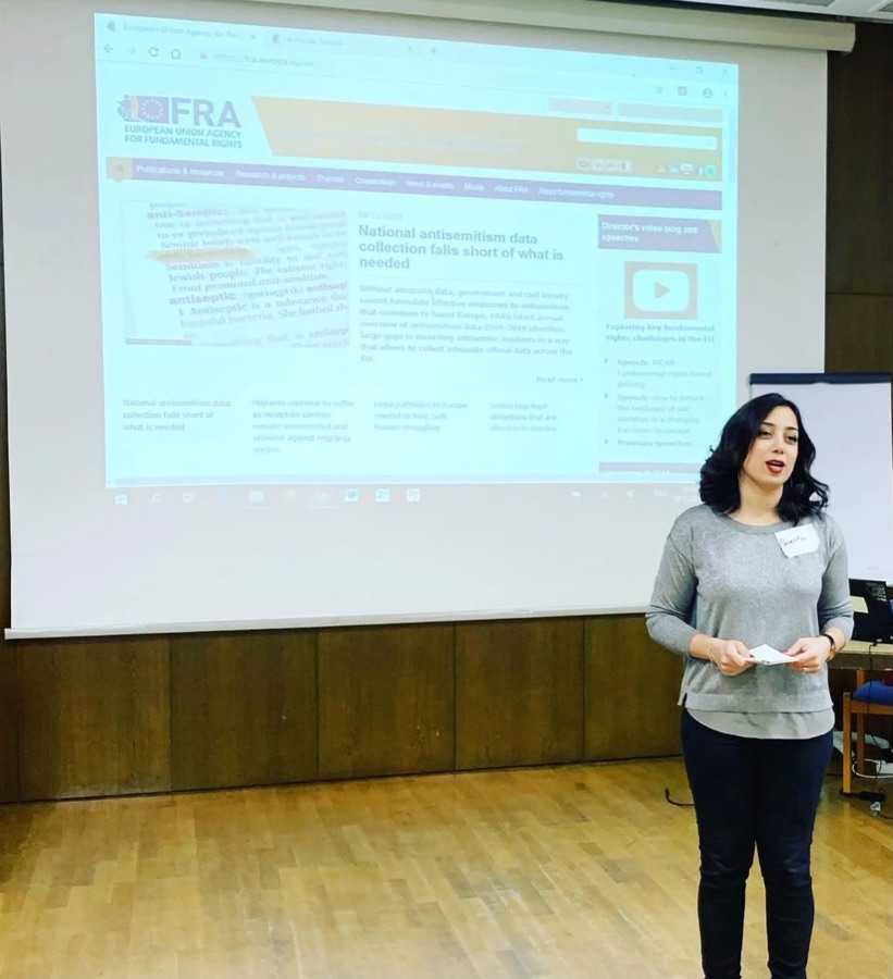 Parastoo Fatemi presenting in front of a projected slide