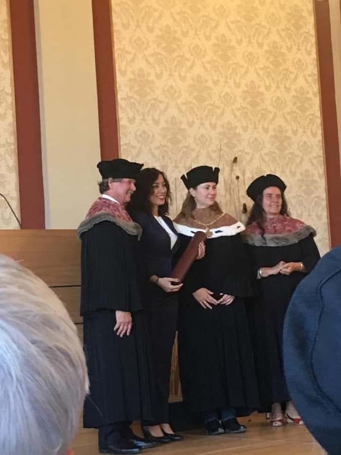 Parastoo Fatemi receiving her diploma from university officials in academic robes