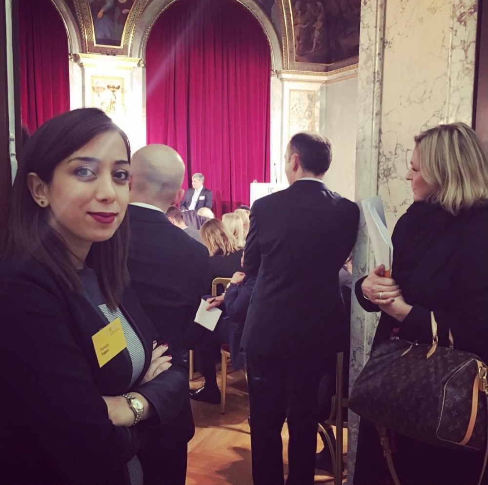 Parastoo Fatemi with her ICMPD badge in an ornate hall of the Hofburg during a conference session
