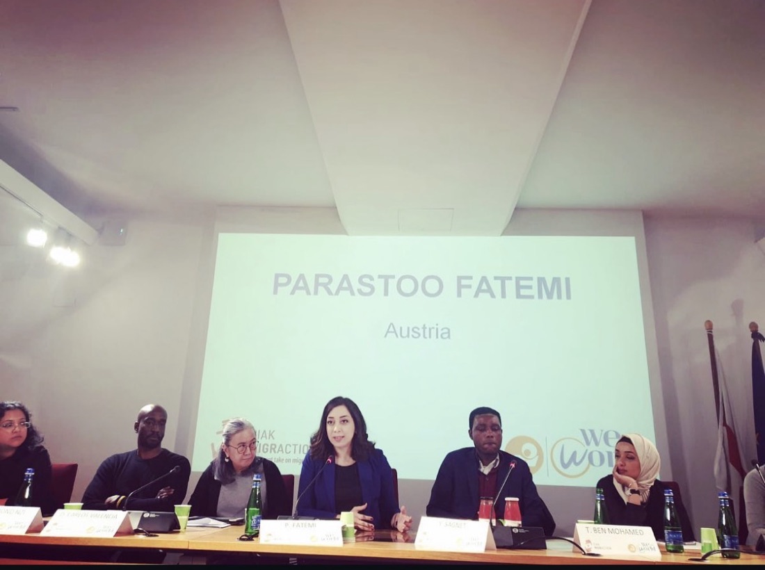 Parastoo Fatemi speaking on a panel at Palazzo Reale in Milan, her name and Austria on the screen behind her